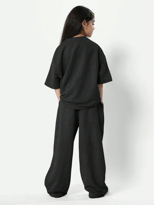 Trendy girls' leopard print oversized t-shirt and matching loose fit trousers for a bold, comfy look