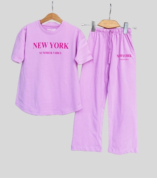 Young girl wearing a relaxed, oversized t-shirt with wide-leg loose fit trousers, styled for comfort and ease.