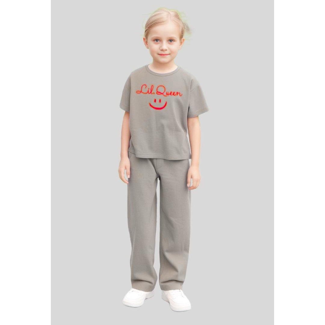 Young girl wearing a relaxed, oversized t-shirt with wide-leg loose fit trousers, styled for comfort and ease.