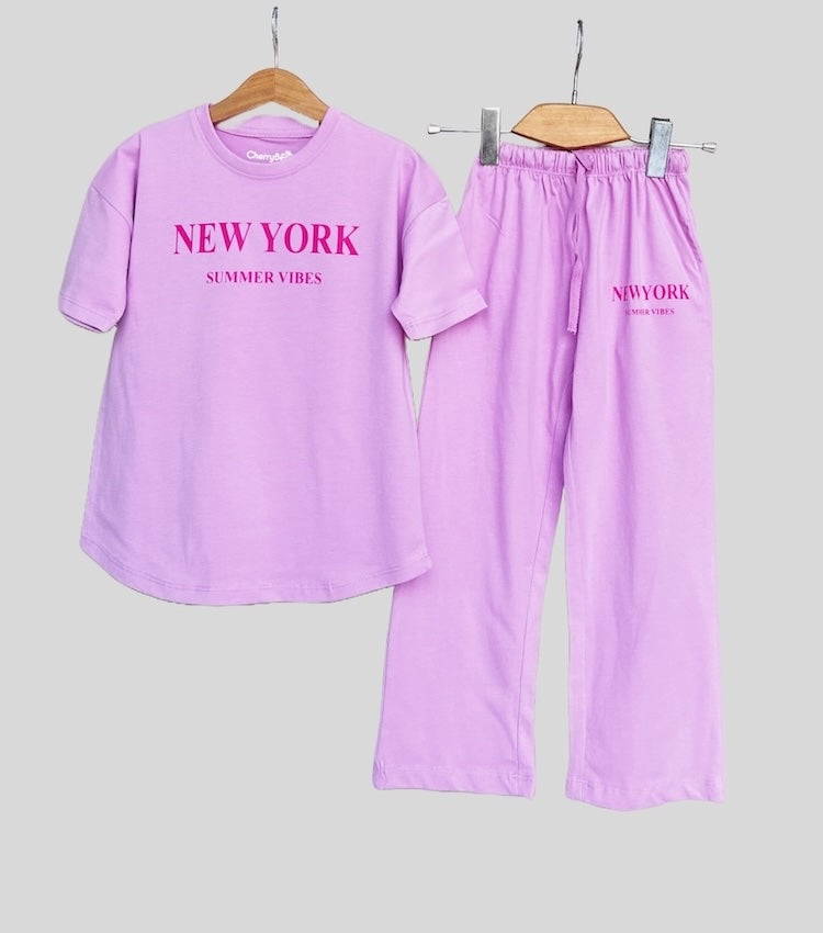 Oversized short sleeve t-shirt paired with loose fit trousers for girls, perfect for a laid-back casual look.
